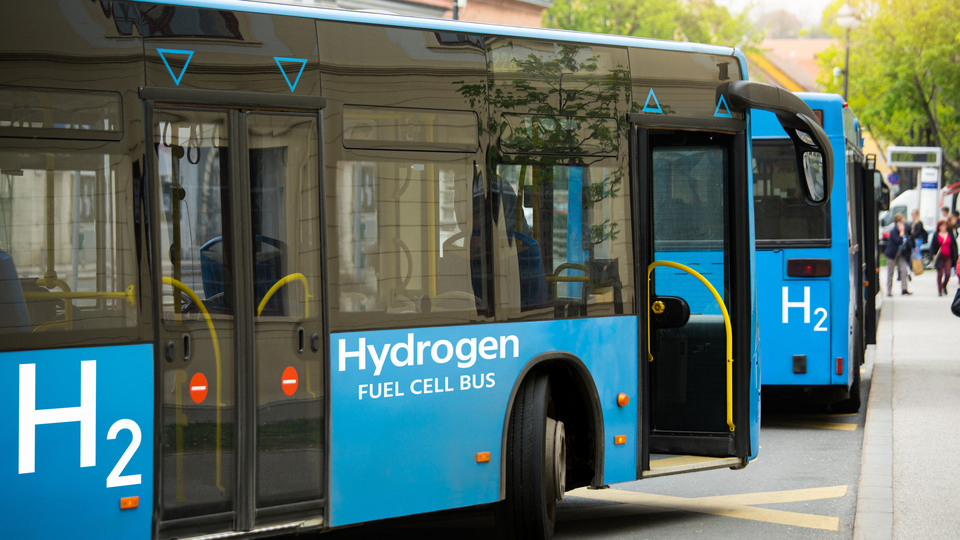 A hydrogen fuel cell buses stands at the station