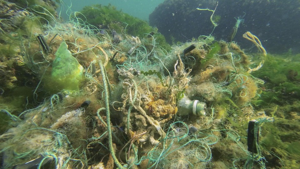 Lost fishing gear lies underwater on the seabed. Problem of ghost gear - any fishing gear that has been abandoned, lost or otherwise discarded. It is the most harmful form of marine debris